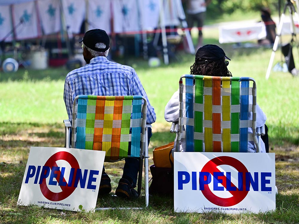 People display signs opposing the Mountain Valley Pipeline during an August 2021 rally in Burlington, North Carolina. (Wikimedia Commons/Anthony Crider)