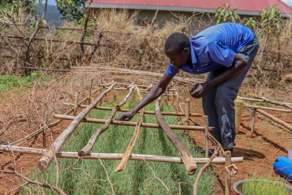 Raymond Okello tends to the backyard garden at his home in rural Karamoja, Uganda, April 20, 2021. (CNS/CRS/Kato Chrysestom)