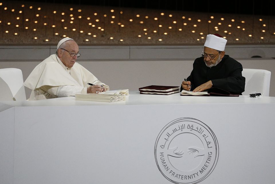Pope Francis and Sheik Ahmad el-Tayeb, grand imam of Egypt's Al-Azhar mosque and university, sign documents during an interreligious meeting Feb. 4, 2019, at the Founder's Memorial in Abu Dhabi, United Arab Emirates. (CNS/Paul Haring)