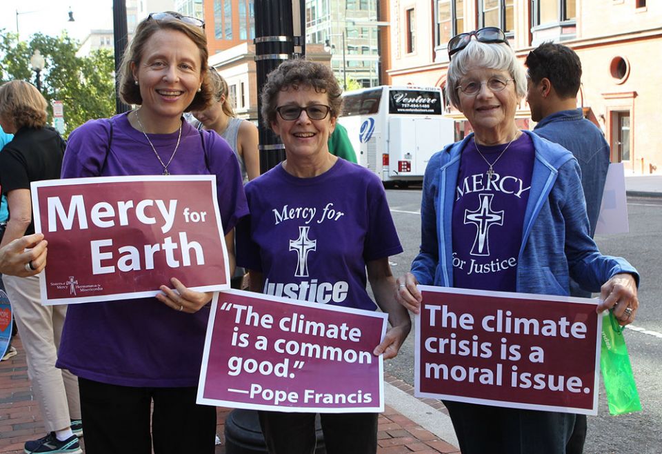 Mercy Sister Aine O'Connor, Marianne Comfort, justice coordinator for the Mercy Sisters, and Mercy Sister Rita Parks hold aloft signs Sept. 20, 2019, in front of St. Patrick's Church in Washington as they prepare to join a climate change march. (CNS) Mercy Sister Aine O'Connor, Marianne Comfort, justice coordinator for the Mercy Sisters, and Mercy Sister Rita Parks hold aloft signs Sept. 20, 2019, in front of St. Patrick's Church in Washington as they prepare to join a climate change march. (CNS)