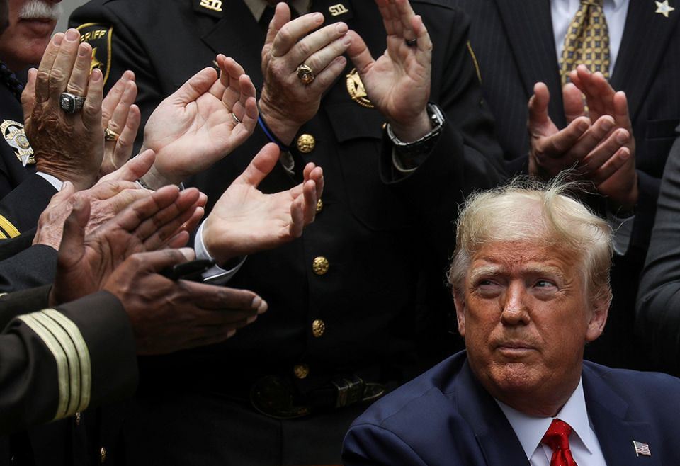 President Donald Trump listens to applause after signing an executive order on police reform at the White House in Washington June 16, 2020. (CNS/Reuters/Leah Millis) President Donald Trump listens to applause after signing an executive order on police reform at the White House in Washington June 16, 2020. (CNS/Reuters/Leah Millis)