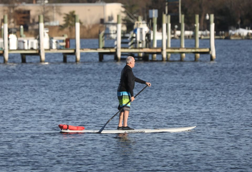 A man rides on a paddleboard on the Chesapeake Bay in Solomons, Md., Dec. 16, 2021. (CNS/Bob Roller)