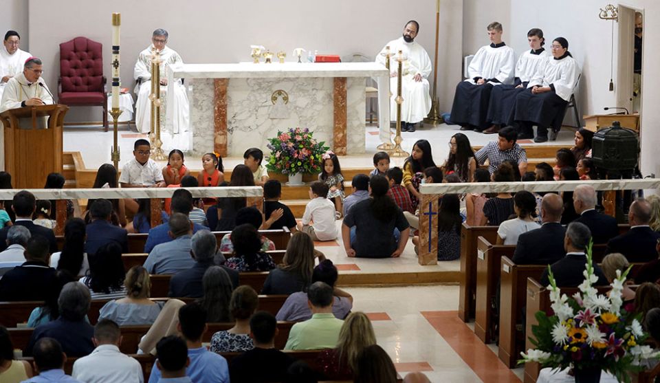 Children at Sacred Heart Catholic Church in Uvalde, Texas, attend Mass with President Joe Biden and first lady Jill Biden May 29. A gunman killed 19 children and two teachers at Robb Elementary School May 24. (CNS/Reuters/Jonathan Ernst)