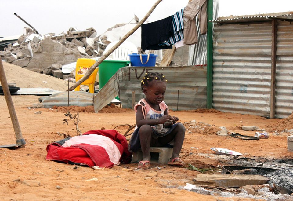 A girl is pictured in a file photo outside her home in Luanda, Angola. According to Caritas Africa, more than 40 million Africans are in extreme poverty due to the pandemic. (CNS/Reuters/Henrique Almeida)