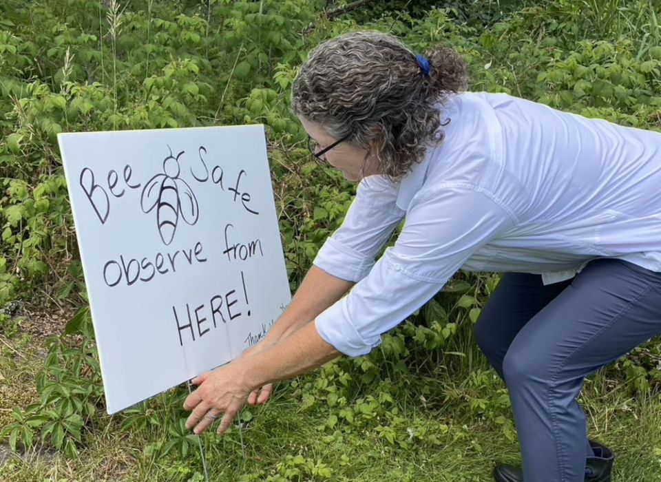 Cindy Thompson adjusts a sign at the Mercy Ecospirituality Center in Benson, Vermont. She and her husband, Chris Thompson, spent six weeks in a Sisters of Mercy program. (Marybeth Redmond)