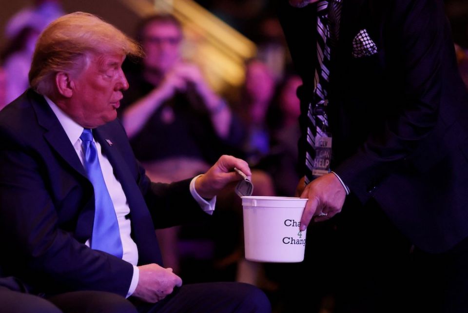 President Donald Trump donates money during a worship service at the International Church of Las Vegas in Las Vegas Oct. 18. (CNS/Reuters/Carlos Barria)