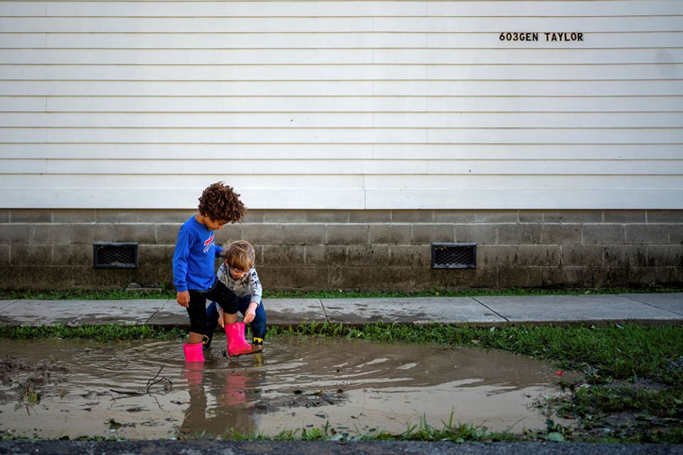 Children in New Orleans play in a puddle after Hurricane Zeta swept through the area Oct. 29, 2020. (CNS/Reuters/Kathleen Flynn)
