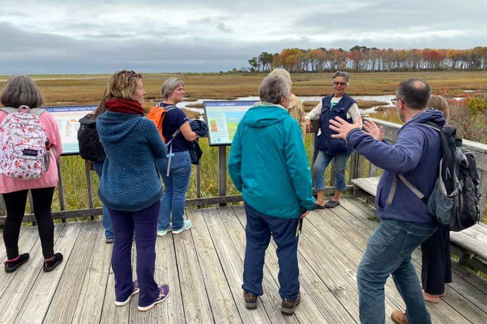 People attend a Wonder and Wander daylong retreat organized by The BTS Center at Wells Reserve in Wells, Maine, in autumn 2021. Maine Master Naturalist Linda Littlefield Grenfell, top right, led the excursion. (RNS/The BTS Center)
