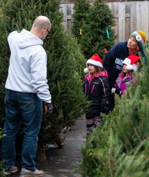 Gregg Michalski holds a Christmas tree for his wife, Joanne, and their daughters, Kendra and Paige, to examine at the Knights of Columbus Christmas tree lot in De Pere, Wisconsin, Dec. 1, 2018. (CNS/The Compass/Sam Lucero) Gregg Michalski holds a Christmas tree for his wife, Joanne, and their daughters, Kendra and Paige, to examine at the Knights of Columbus Christmas tree lot in De Pere, Wisconsin, Dec. 1, 2018. (CNS/The Compass/Sam Lucero)