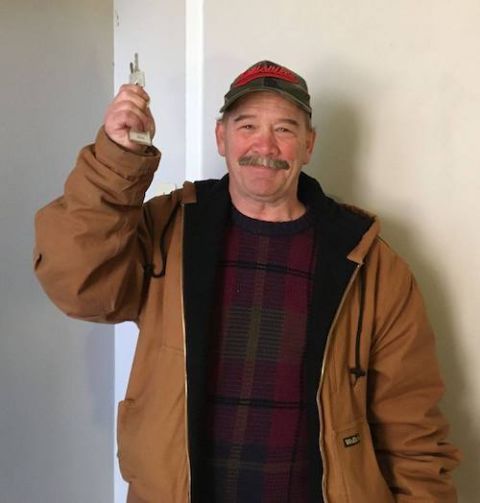 Kenny, a former resident of the St. John's Center in Louisville, Kentucky, shows the keys to his new apartment. (Maria Price)