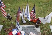 Flags and other items surround the grave where Franciscan Father Mychal F. Judge, a chaplain of the New York Fire Department, is buried at Holy Sepulchre Cemetery in Totowa, New Jersey.  Judge died in the Sept. 11, 2001, World Trade Center attacks. (CNS/O