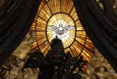The Holy Spirit window is pictured through the Baldacchino in St. Peter's Basilica at the Vatican. (CNS/Paul Haring)