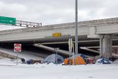 A homeless encampment is pictured under a highway overpass Feb. 16, 2020, during a winter storm in Austin, Texas. Austin planned to operate over a dozen warming shelters around the clock for the city's vulnerable population until the historic cold outbrea