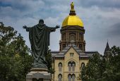A statue of Jesus facing the Golden Dome with its statue of Mary atop the administration building of the University of Notre Dame is seen Aug. 6 in Notre Dame, Indiana. (CNS/Chaz Muth)
