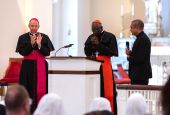 Baltimore Archbishop William E. Lori, left, leads a round of applause for Guinean Cardinal Robert Sarah May 15, 2022. (CNS photo/Kevin J. Parks, Catholic Review)