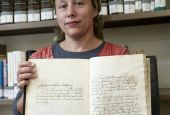 Pnina Younger, archivist at Central Archives for the History of the Jewish People at the Israel National Library, holds a rare 18th-century manuscript with details of the Portuguese Inquisition in Jerusalem July 19, 2022. (CNS photo/Debbie Hill)