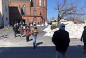 Parishioners walk on the snow-cleared parking lot of St. Patrick Church in Lawrence, Massachusetts, to assemble in winter for Mass outdoors. (Courtesy of St. Patrick Parish)