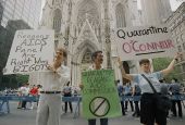 Demonstrators hold signs in front of St. Patrick's Cathedral in New York City on Aug. 2, 1987, to protest the appointment of Cardinal John O'Connor to a national AIDS panel, which gay rights activists said was "stacked" against them. (AP/Mario Cabrera)