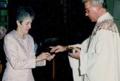 The author's mother, Carmen Nanko, receives Communion from Fr. Robert Poveromo. (Courtesy of Chip and Karen Nanko)