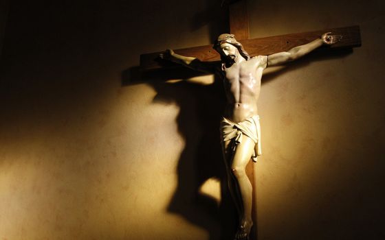 Evening light shines on a crucifix in the vestibule of St. Paul's Basilica in Toronto in this 2008 file photo. In his new book, James Keenan begins his narrative with the New Testament. (CNS/Nancy Wiechec)