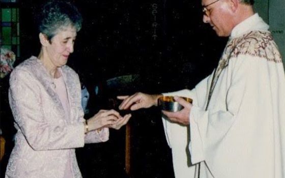 The author's mother, Carmen Nanko, receives Communion from Fr. Robert Poveromo. (Courtesy of Chip and Karen Nanko)